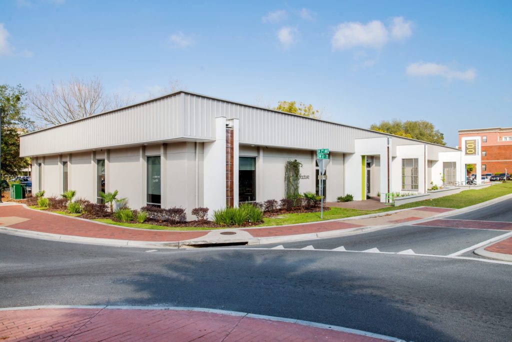 Exterior view of Fracture's modern office building on a sunny day, showcasing its sleek design 