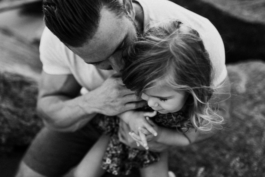 capturing a tender and emotional moment of connection in a candid black-and-white photo