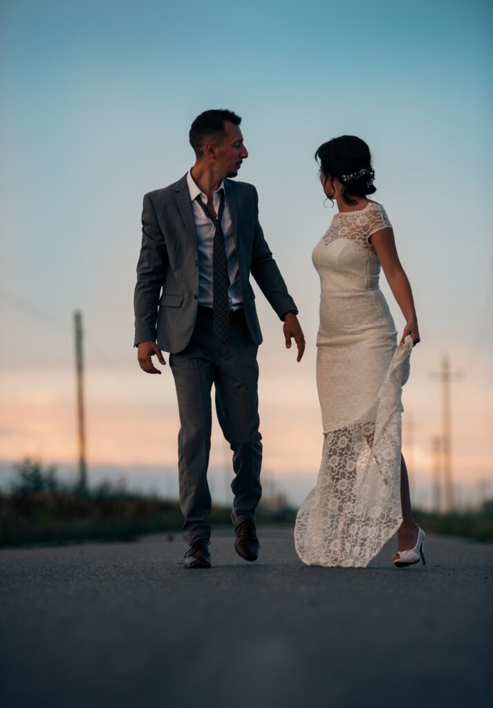 Bride and groom embracing in front of a beautiful sunset