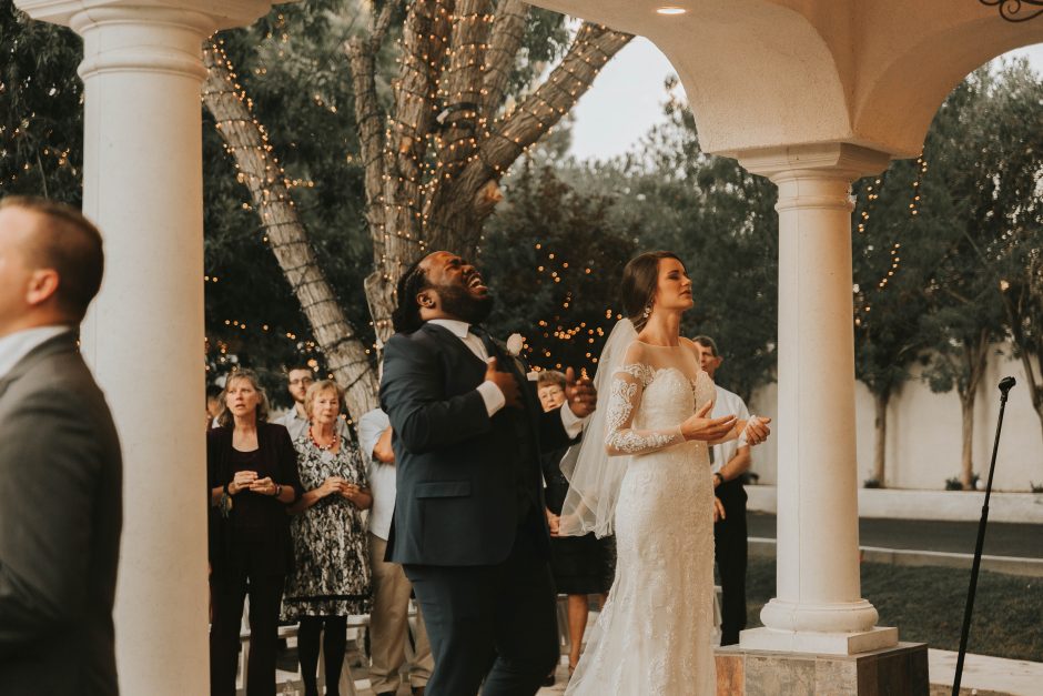 Wedding photographer capturing a candid moment of the couple during their ceremony