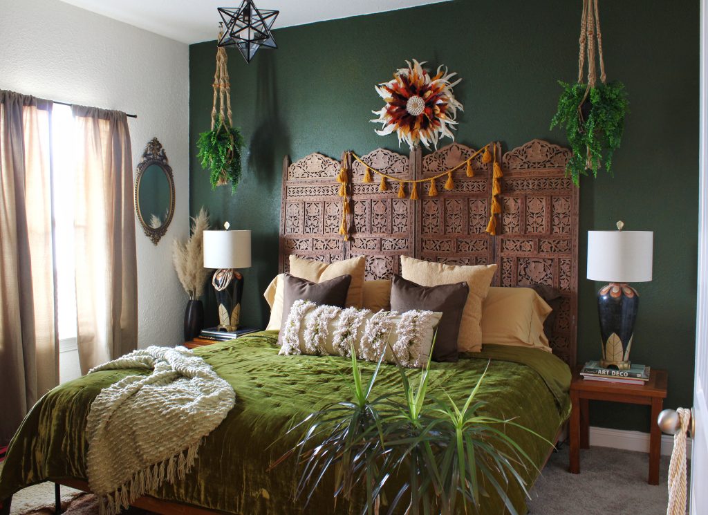 Bohemian bedroom with intricate wooden headboard, hanging plants, creating a serene and stylish space