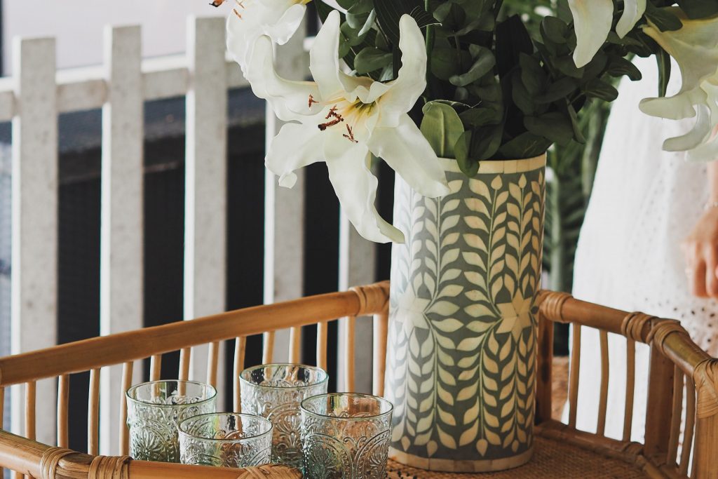 Add greenery or florals for bar cart styling