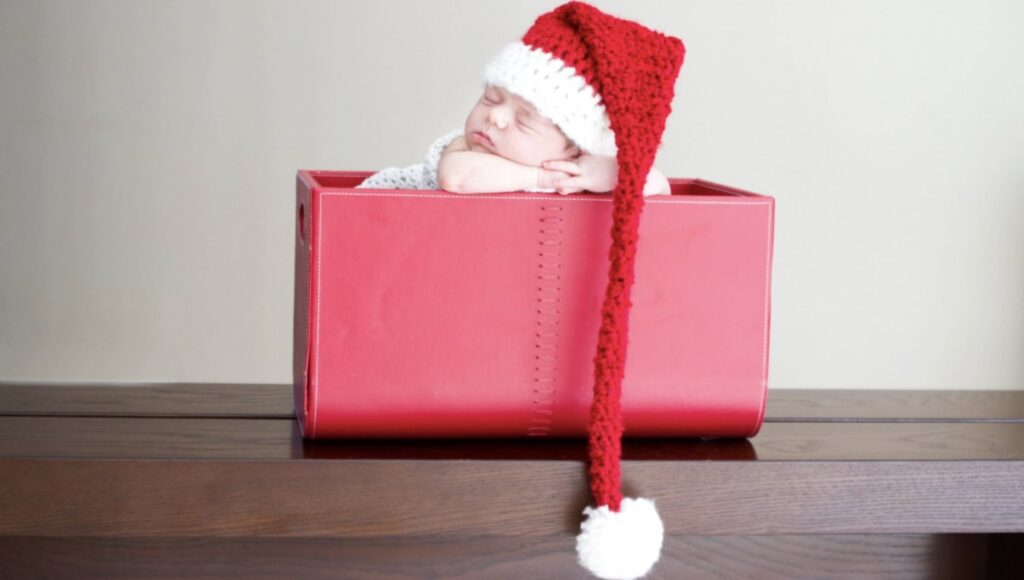 Baby's photo shoot with a santa hat