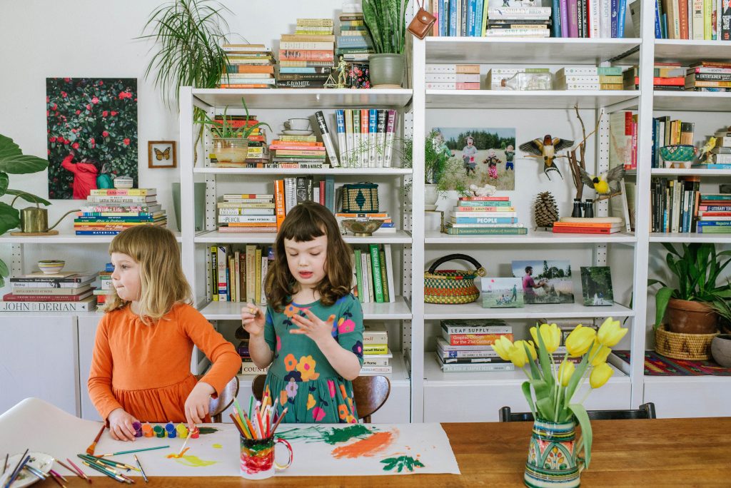 Children painting in maximalist decor space