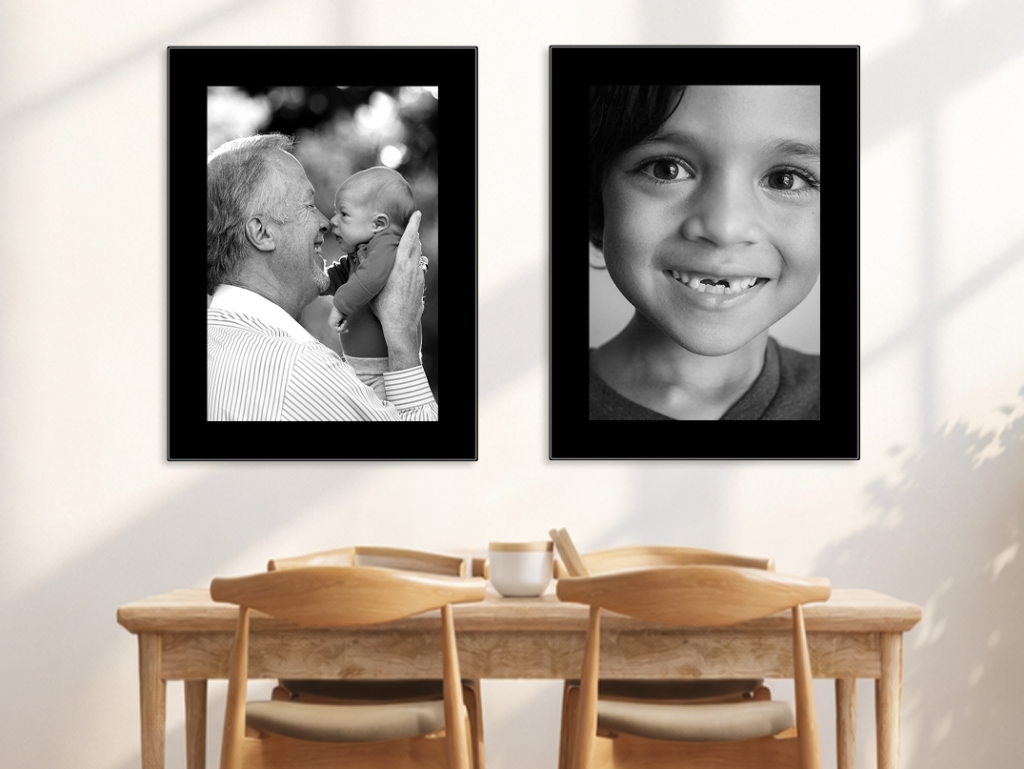 Two large Fracture Glass Prints mounted above a table with black borders printed on the glass, complementing the black and white photos.
