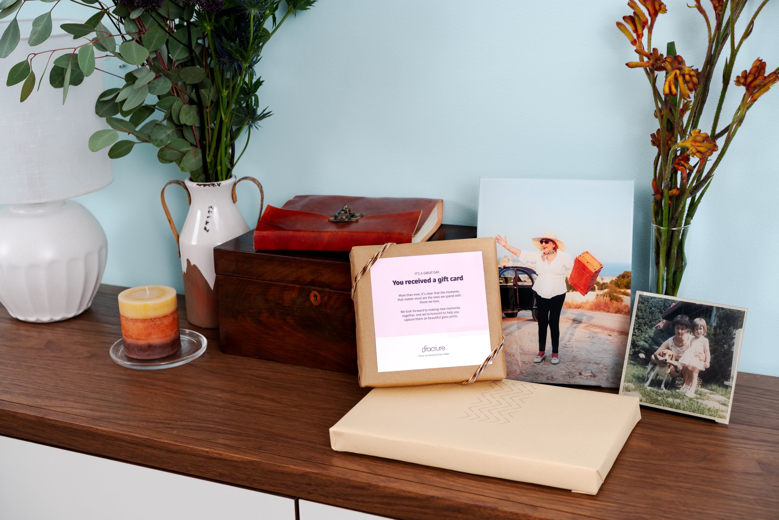 The Best Mother's Day Gifts That Don't Feel Last Minute (Even If They Are). Two Glass Prints of moments with mom sit in a stand next to a Fracture Gift Card and gift box.