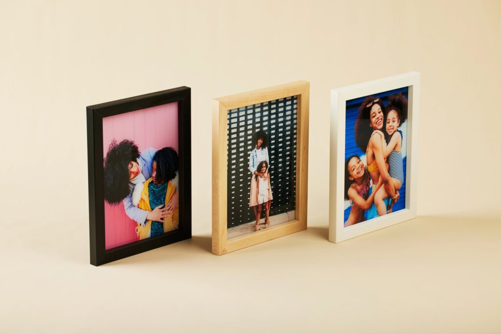 Three Mother's Day photos printed on glass and personalized with a different colored wood frame on each.