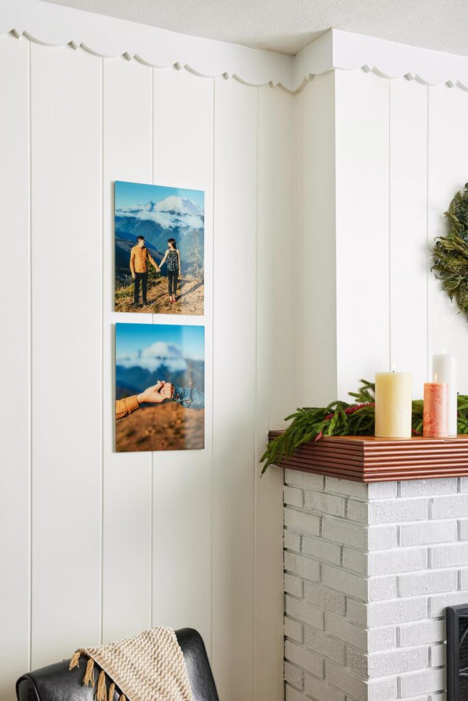Wedding gifts don't have to be limited to just the wedding photos: A couple's engagement photos printed on glass hang on a wall next to a fireplace decorated for Christmas.